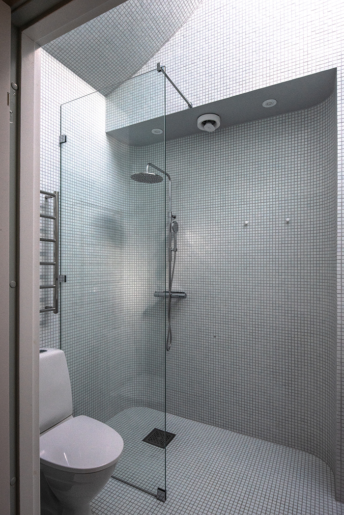 Bathroom with curved mosaic walls and a skylight