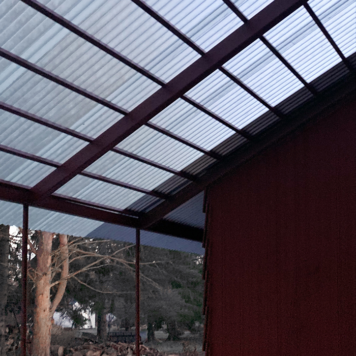 The big patio has a semi transparent roof with the same sinus curve profile as the steelroof.